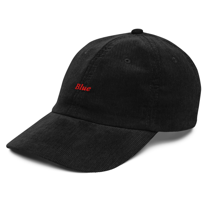 Blue, black corduroy cap that says Blue in red thread